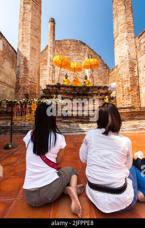 Autthaya Historical Park, Mädchen beten, Wat Maheyong, Haupttempel, buddha-Statuen, Ayutthaya, Thailand, Südostasien, Asien Stockfoto