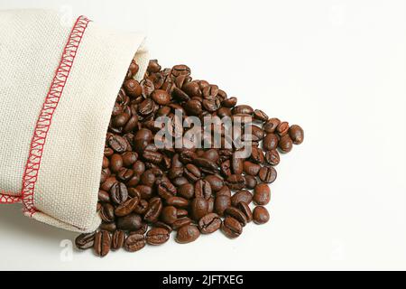 Kaffeebohnen in einer Tüte. Die Kaffeebohne ist aus dem Beutel verschüttet. Copispace Stockfoto