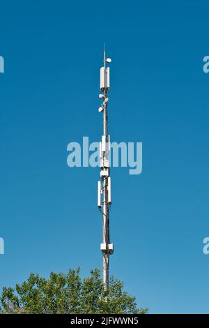 Telecommunication cell Tower Antenne gegen blauen Himmel. Drahtlose Kommunikation und modernes mobiles Internet. Stockfoto
