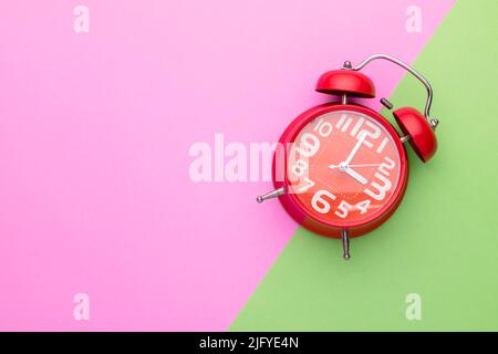 Blick auf alten roten Wecker auf hellen Hintergrund Stockfoto