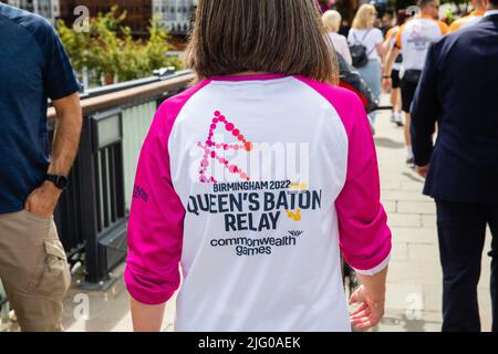 Windsor und Eton, Großbritannien. 6.. Juli 2022. Ein Mitglied des Teams des Queen's Baton Relay überquert die Windsor Bridge. Das Queen's Baton befindet sich derzeit auf einer 25-tägigen Tour durch die englischen Regionen auf dem Weg zu den Commonwealth Games. Kredit: Mark Kerrison/Alamy Live Nachrichten Stockfoto