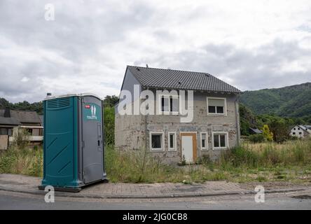 Altenahr, Deutschland. 06.. Juli 2022. Ein mobiles Toilettenhaus steht vor einem unbewohnten Haus in Altenahr. Am 14. Juli jährt sich die Katastrophe zum ersten Mal. Quelle: Boris Roessler/dpa/Alamy Live News Stockfoto