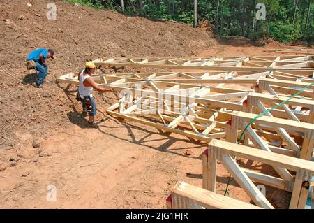 Lateinischen Belegschaft Gebäude Holzstab gebaut Haus Hause schneiden Maßnahme Nagelung an heißen Tag Stockfoto