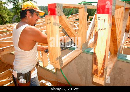 Lateinischen Belegschaft Gebäude Holzstab gebaut Haus Hause schneiden Maßnahme Nagelung an heißen Tag Stockfoto