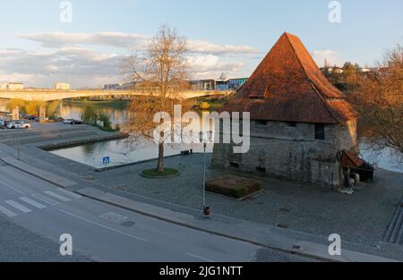 MARIBOR, Slowenien - 10. April 2022: Mittelalterlicher Wasserturm entlang der Drau bei Sonnenuntergang Stockfoto