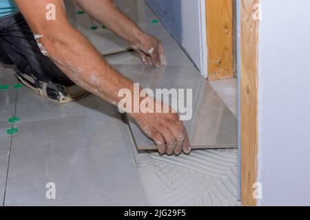 Fliesenmontage auf Klebeflächen während des Hausbaus Stockfoto