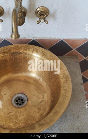 Goldwaschbecken und Wasserhahn im Vintage-Stil Stockfoto