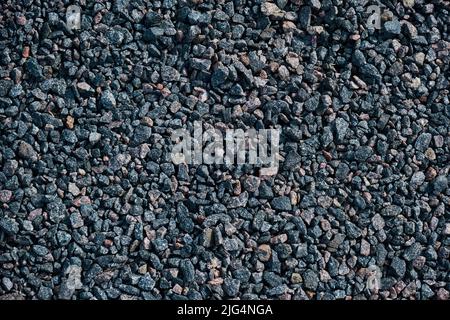 Grau kleine Felsen Boden Textur schwarze Straße Stein Hintergrund Kiesel Stockfoto