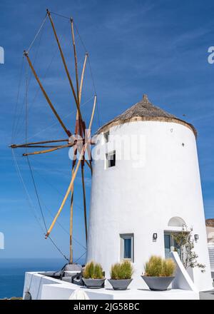 Ikonische weiße Windmühle im Dorf Oia, Santorini, Griechenland Stockfoto