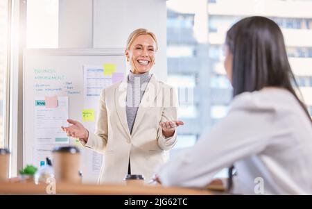 Ihre Ideen direkt in Erfolg umsetzen. Aufnahme einer reifen Geschäftsfrau, die sich in einem Büro mit ihrem Kollegen trifft. Stockfoto