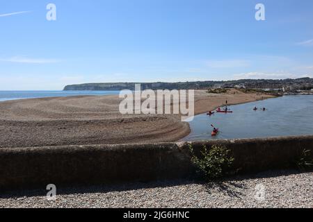 AXMOUTH, DEVON, ENGLAND - JULI 12. 2020: Kanus machen ihren Weg entlang der Axe in Richtung des Yachthafens bei Axmouth Stockfoto