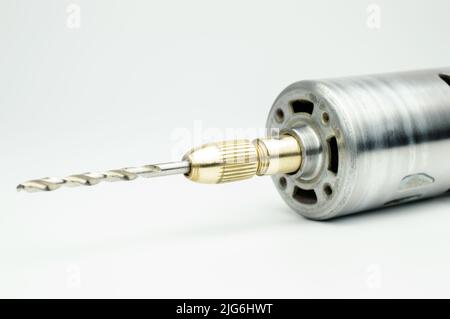 Elektrische Mikrobohrmaschine zum Bohren von Leiterplatten. Kleine Bohrmaschine aus Stahl. DC-Bürstenmotor. Selektiver Fokus. Stockfoto