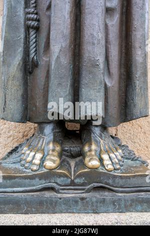 Die Füße einer Bronzestatue des Patrons von San Pedro de Alcantara der Diözese Caceres in Extramdura, Spanien, mit glänzenden Kanten, an denen die Menschen berührt haben Stockfoto