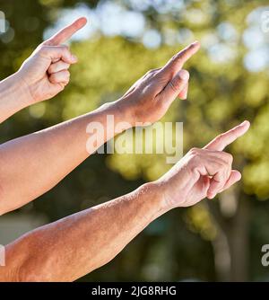 Was ist das da drüben? Aufnahme einer Gruppe von nicht erkennbaren Männern, die im Freien nach oben zeigen. Stockfoto