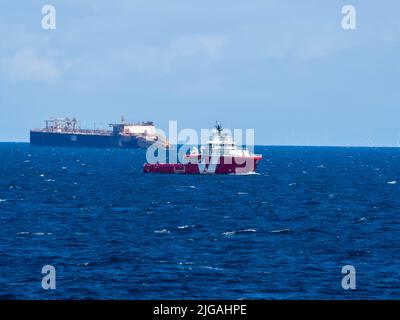 VOS ENDURANCE (IMO: 9488152, MMSI 235082004) ist ein 2010 gebautes Offshore-Schlepper-/Versorgungsschiff mit Offshore-Lagerungskahn im Hintergrund. Stockfoto