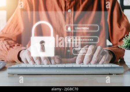Man Hand tippen auf der Tastatur mit Login und Passwort auf dem Bildschirm, Cyber-Security-Konzept, Datenschutz und gesicherten Internetzugang. Stockfoto