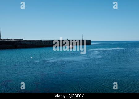 Boote, die Porthleven Harbour, Cornwall verlassen Stockfoto