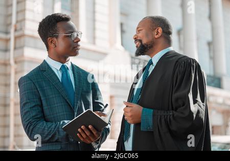 Lernen von den Besten. Zwei männliche Anwälte im Gespräch in der Stadt. Stockfoto