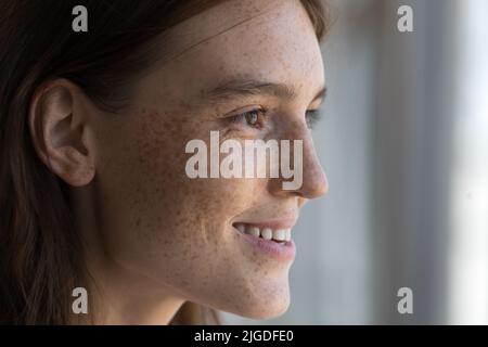 Profilansicht Gesicht einer jungen, in die Ferne starrenden Sommersprossen-Frau Stockfoto