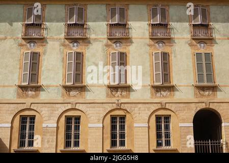 Seite des alten Gebäudes mit mehreren Fenstern, Brescia, Lombardia, Italien Stockfoto