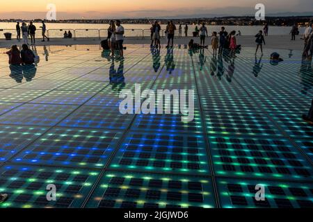 Besucher bei Nikola Basic's Sun Salutation Lighting Display, Istarska Obala Promenade, Zadar, Kroatien Stockfoto