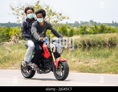 SAMUT PRAKAN, THAILAND, MAI 05 2022, Ein zwei Herren fährt auf dem Motorrad auf der sonnigen Straße Stockfoto