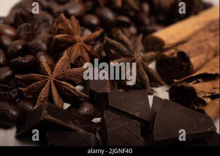 Zimt, Sternanise, Kaffeebohnen und dunkle Schokolade aus nächster Nähe Stockfoto