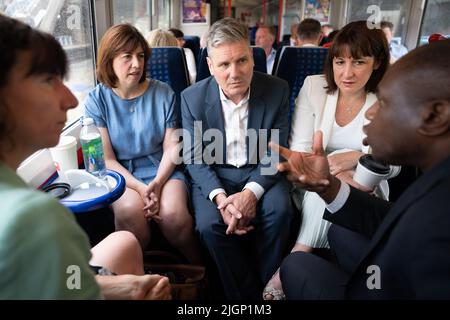 Der Gewerkschaftsführer Sir Keir Starmer (Mitte) mit der Schattenministerin für Frauen und Qualitäten Anneliese Dodds (ganz links), der Sekretärin der Schattenkultur, Lucy Powell (links), der Schattenkanzlerin, Rachel Reeves und dem Schattenaußenminister, David Lammy, während sie mit anderen Mitgliedern seines Schattenkabinetts im Zug nach High Wycombe, Buckinghamshire, fahren, Eine Sitzung des Schattenkabinetts im Adams Park, der Heimat des Fußballclubs Wycombe Wanderers, abzuhalten. Bilddatum: Dienstag, 12. Juli 2022. Stockfoto