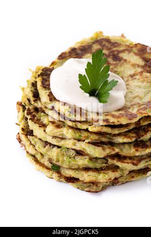 Zucchini-Krapfen mit Joghurt-Sauce isoliert auf weißem Hintergrund Stockfoto