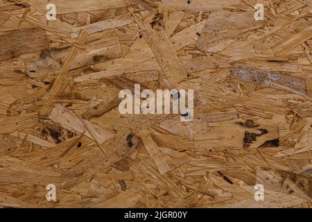 Oriented Strang Board OSB Tapete. Abstrakter Holzhintergrund. Das natürliche Holzbaumaterial für die Veredelung. Holzverarbeitung im Abfall. Material mit Holzstruktur. Stockfoto