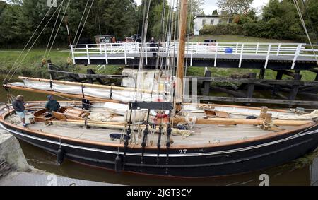 Das Tall-Schiff Mascotte macht sich am Freitag, den 15.. Oktober 2021, auf den Weg auf den Gloucester zum Sharpness Canal in Gloucestershire, wo sie am T.Nielsen and Company Shipbuilders and Riggers in Gloucester Docks ihren Winternachbau durchgeführt hat. Nielsen kümmert sich seit vielen Jahren um Mascotte, und sie kommt jährlich für Trockendocks und Vermessungen. Sie wird bis März 2022 in Gloucester sein.Mascotte ist ein Bristol Channel Pilot Cutter, der 1904 in Newport gebaut wurde und das größte überlebende Schiff ihres Typs ist. Die Pilot Cutters rasten aus den Häfen des Bristol Channel, um große Schiffe zu treffen und Piloten an Bord zu liefern, um sie sicher hineinzuführen Stockfoto