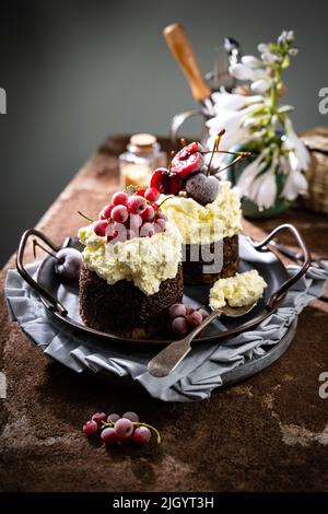 Süßes Schokoladendessert mit Creme und gefrorenen Früchten.leckeres Essen und Trinken.hausgemachter Kuchen Stockfoto