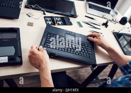 Tastatur des zerlegten Laptops, Reparaturman pov Stockfoto