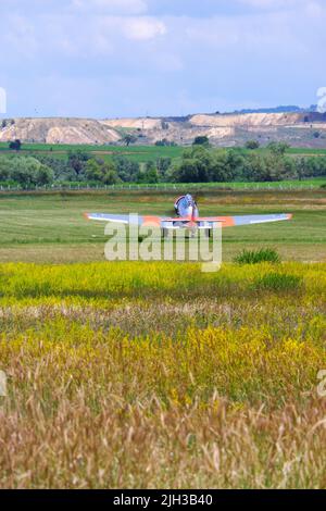 Kleines Flugzeug steuerte Hügel zum Abheben vom Glas Stockfoto