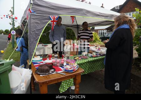 Die Leute am Cake Stall bei der Street Party feiern das Platin-Jubiläum von Queen Elizabeth II in Surrey England Stockfoto