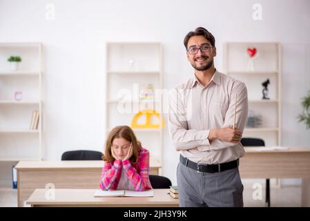 Junge Lehrerin und Rotschopf im Klassenzimmer Stockfoto