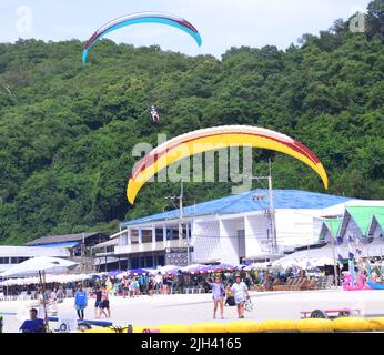 Menschen Paragliding Landung an der Küste auf der Insel Koh Larn, die Ko Larn oder Ko Laan oder Ko Lan, Thailand, Asien buchstabiert werden kann. Thailand, Asien, Stockfoto