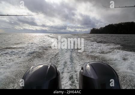 Ein Außenbordmotor wacht an einem bewölkten Tag auf der Insel Langara in Hai von einem Motorschiff auf dem Meer in einer Meereslandschaft mit dem Horizont über dem Wasser auf Stockfoto