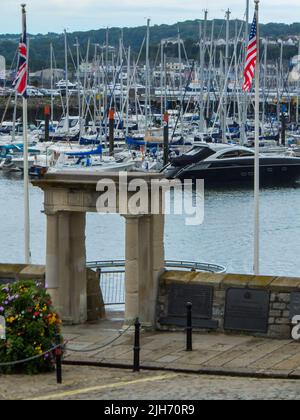 Blick über die historische Mayflower-Treppe zu den Booten, die in Sutton Harbour in Plymouth, Devon, England, Großbritannien, vertäut sind. Stockfoto