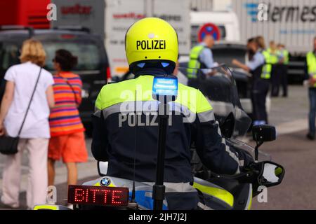 Ratingen, Deutschland. 16.. Juli 2022. An der Rasthaltestelle Hösel auf der Autobahn 3 steht ein Motorradpolizist mit blauem Licht. Die Polizei nutzt die Hälfte der Sommerferien als Gelegenheit für landesweite Verkehrskontrollen. Kredit: David Young/dpa/Alamy Live Nachrichten Stockfoto