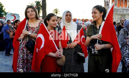 Izmir, Türkei. 15.. Juli 2022. Menschen mit türkischen Flaggen, einige von ihnen mit Präsident Erdogan und osmanischer Flagge, nahmen am 15. Juli an den Veranstaltungen zum Tag der Demokratie und nationalen Einheit Teil, um den 15. Juli zu feiern, der den Putsch am Konak-Platz besiegte. Beim gescheiterten Putschversuch vom 15.. Juli 2016 wurden 249 Menschen gemartert und fast 2.200 Menschen verletzt. (Foto von Idil Toffolo/Pacific Press) Quelle: Pacific Press Media Production Corp./Alamy Live News Stockfoto