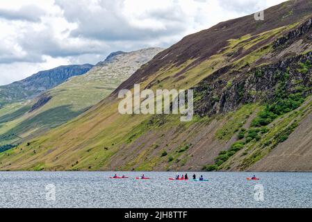 Kanufahrer am Waster Lake, an einem Sommertag, mit der dramatischen zerklüfteten Landschaft im Hintergrund Wasdale Cumbria England Stockfoto