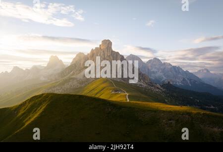 Blick von oben, atemberaubende Luftaufnahme des Giau-Passes bei einem wunderschönen Sonnenuntergang. Der Giau Pass ist ein Hochgebirgspass in den Dolomiten. Stockfoto