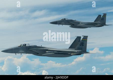 Ein Paar F-15 Adler mit dem 159. Fighter Wing aus Louisiana fliegen neben einem KC-135 Stratotanker mit dem 914. Air Betanking Wing Wing, New York, 10. Juli 2022, über den Südosten der Vereinigten Staaten. Der 159. Fighter Wing trägt den Spitznamen „Bayou-Miliz“, der auf beiden Schwänzen der F-15 zu sehen ist. (USA Luftwaffe Foto von Airman Kylar Vermeulen) Stockfoto