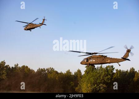 Soldaten, die Alpha und Bravo Company, 1. Bataillon, 114. Infanterie-Regiment, 44. Infanterie-Brigade-Kampfteam, New Jersey Army National Guard zugeordnet sind, werden von UH-60 Blackhawks bei der exportable Combat Training Capability (XCTC) Übung in Fort Drum, New York, transportiert. Mehr als 2.500 Soldaten nehmen an der Trainingsveranstaltung Teil, die es Brigadekampfteams ermöglicht, die geschulte Zugbereitschaft zu erreichen, die für Einsatz, Kampf und Sieg erforderlich ist. (USA Foto der Armee-Nationalgarde von Sgt. Benjamin Martinez) Stockfoto