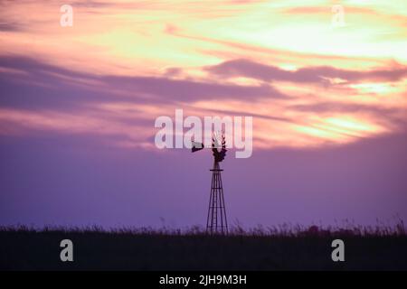 Windmühle bei Sonnenuntergang in der argentinischen Landschaft, Provinz Pampas, Patagonien, Argentinien. Stockfoto