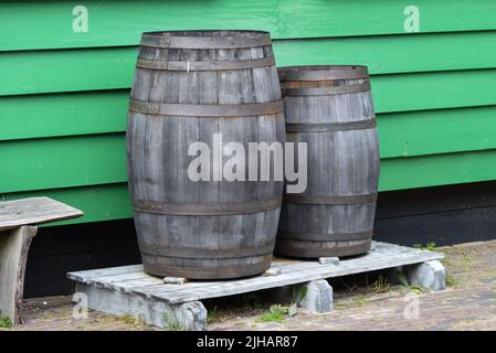 Koog aan de Zaan, Niederlande. juli 2022. Zwei alte Fässer vor einem Hintergrund aus Holzplatten. Hochwertige Fotos Stockfoto