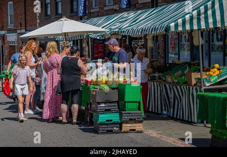 Grantham, Lincolnshire, Großbritannien – Einkäufer auf dem traditionellen Straßenmarkt in der Stadt, der Obst und Gemüse sowie Obst verkauft Stockfoto