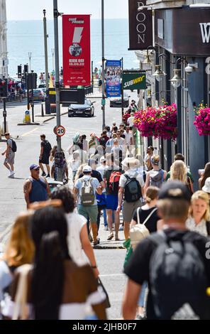Brighton UK 17. July 2022 - Menschenmassen fahren nach der Ankunft mit dem Zug an einem heißen, sonnigen Tag zum Strand von Brighton, da für die nächsten zwei Tage im ganzen Land eine extrem rote Wetterwarnung ausgegeben wurde : Credit Simon Dack / Alamy Live News Stockfoto