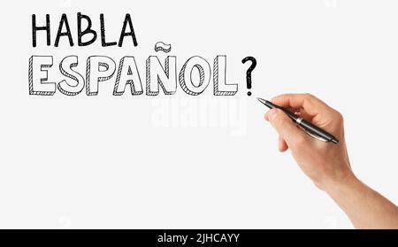 Handschriftentext HABLA ESPANOL? (SPRECHEN SIE SPANISCH?) Auf weißem Hintergrund Stockfoto